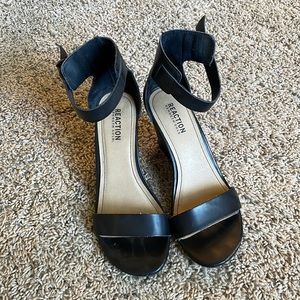 Woman’s black strapped heels